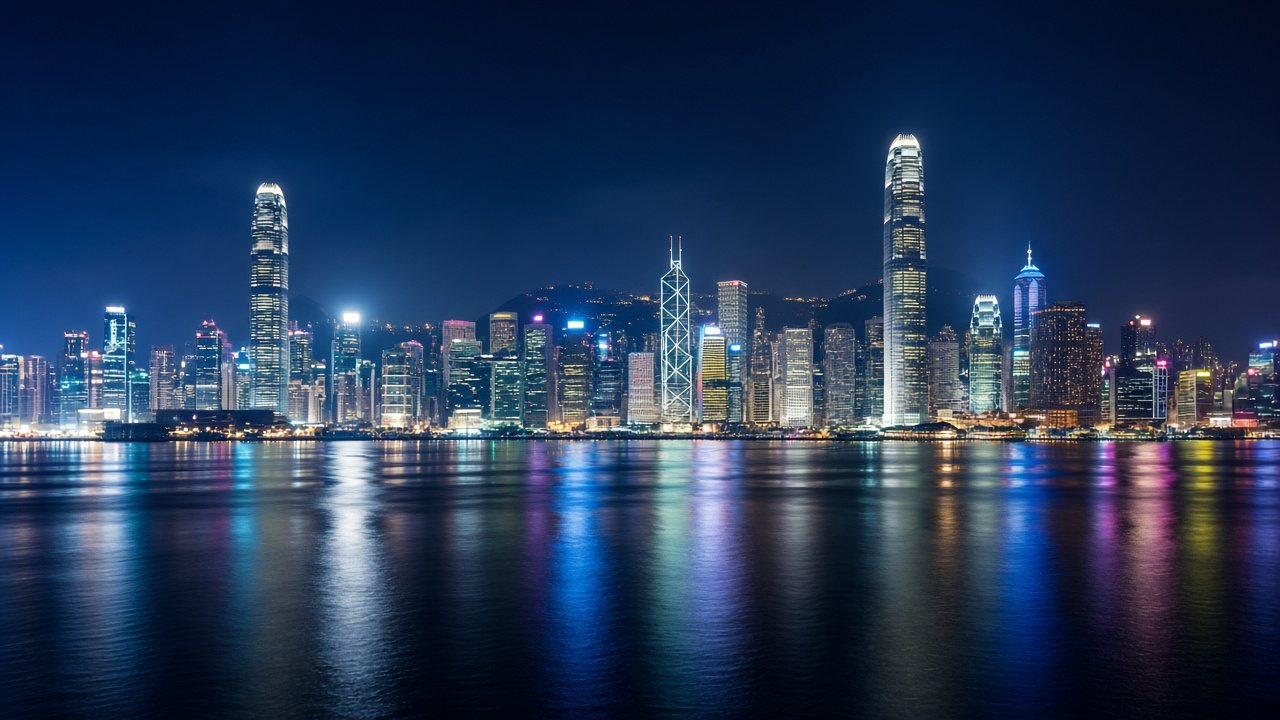 Hong Kong skyline at night across Victoria Harbour, seen from Tsim Sha Tsui.